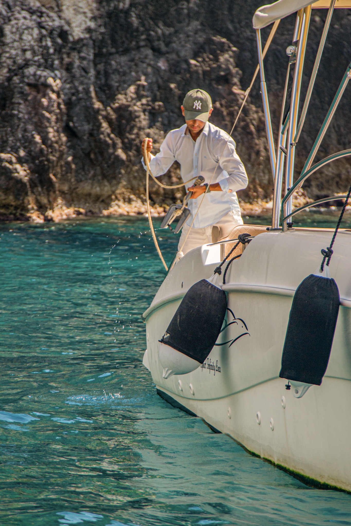Preparing the anchor beside the clear water on the Aquabat 850 Sport Infinity Lux