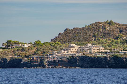 Buildings and green hills along the island shore